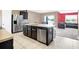 Modern kitchen with stainless steel appliances and dark cabinetry at 180 Grove Branch Rd, Winter Haven, FL 33880