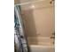 Cozy bathroom featuring a tub with tiled walls and a decorative floral shower curtain at 1820 Coriander Dr, Poinciana, FL 34759