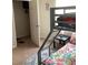 Functional bedroom features a bunk bed with colorful bedding and a nearby closet at 1820 Coriander Dr, Poinciana, FL 34759
