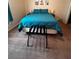 Comfortable bedroom with a bed, side tables, and stylish artwork at 1820 Coriander Dr, Poinciana, FL 34759