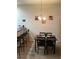 Cozy dining area with modern light fixture and bar seating at 1820 Coriander Dr, Poinciana, FL 34759