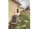 Exterior view of a home with a well-maintained lawn and AC unit at 1820 Coriander Dr, Poinciana, FL 34759