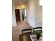 Bright hallway with neutral carpeting and multiple storage closets at 1820 Coriander Dr, Poinciana, FL 34759