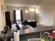 Open-concept living room with a dark couch and entertainment center at 1820 Coriander Dr, Poinciana, FL 34759
