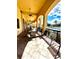 A covered patio features several tables, chairs, ceiling fans and overlooks a community pool at 1820 Coriander Dr, Poinciana, FL 34759