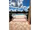 A zero entry pool at a community center features mature tropical landscaping and clear blue skies at 1820 Coriander Dr, Poinciana, FL 34759