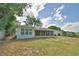Fenced backyard with a screened in porch, mature trees and a tranquil, parklike setting at 1919 19Th Nw St, Winter Haven, FL 33881