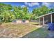 Large backyard with an outdoor shed, screened porch, mature trees and ample space for activities at 1919 19Th Nw St, Winter Haven, FL 33881
