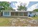 Large screened porch, mature trees, and a fenced yard perfect for and pets to roam freely at 1919 19Th Nw St, Winter Haven, FL 33881