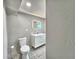Modern bathroom featuring tiled floors, white vanity with double sinks and lighted mirror at 1919 19Th Nw St, Winter Haven, FL 33881