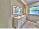 Bathroom featuring double vanity sinks and square mirrors at 1919 19Th Nw St, Winter Haven, FL 33881