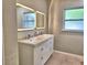 Updated bathroom with double sink vanity, modern mirrors, and contemporary fixtures at 1919 19Th Nw St, Winter Haven, FL 33881