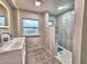 Bright bathroom features a tiled shower, double sink vanity, and a shower with modern fixtures at 1919 19Th Nw St, Winter Haven, FL 33881