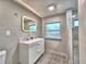 Modern bathroom features a double sink vanity, tile floors, and a walk-in shower at 1919 19Th Nw St, Winter Haven, FL 33881
