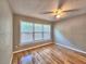 Bright bedroom featuring hardwood floors, a ceiling fan and a large window at 1919 19Th Nw St, Winter Haven, FL 33881
