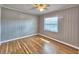 Bright bedroom with hardwood floors, ceiling fan, and natural light from one window at 1919 19Th Nw St, Winter Haven, FL 33881