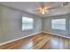 Bright bedroom with hardwood floors, ceiling fan, and natural light from two windows at 1919 19Th Nw St, Winter Haven, FL 33881