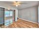 Bedroom with hardwood floors, mirrored closet doors, and a ceiling fan at 1919 19Th Nw St, Winter Haven, FL 33881