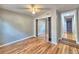 Spacious bedroom with wood floors, mirrored closet doors, and an interior entry way at 1919 19Th Nw St, Winter Haven, FL 33881