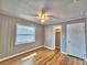 Bedroom featuring hardwood floors, closet, door and natural light from a window at 1919 19Th Nw St, Winter Haven, FL 33881