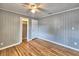 Bedroom featuring hardwood floors, closet, and door at 1919 19Th Nw St, Winter Haven, FL 33881
