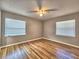 Bright bedroom with hardwood floors, two windows and a ceiling fan at 1919 19Th Nw St, Winter Haven, FL 33881