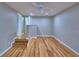 This bedroom has hardwood floors and neutral walls, creating a spacious area that leads to an open closet at 1919 19Th Nw St, Winter Haven, FL 33881