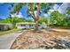 Charming single-story home with a large shade tree and inviting curb appeal at 1919 19Th Nw St, Winter Haven, FL 33881