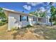 Painted brick exterior with mature landscaping, including a small garden and healthy bushes at 1919 19Th Nw St, Winter Haven, FL 33881