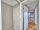 View of a hallway leading to a living area, featuring hardwood floors and neutral walls at 1919 19Th Nw St, Winter Haven, FL 33881