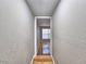 Hallway with hardwood floors leads to a room with a window at 1919 19Th Nw St, Winter Haven, FL 33881