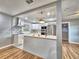 Open concept kitchen with white cabinets, stainless steel appliances, and an island with sink at 1919 19Th Nw St, Winter Haven, FL 33881
