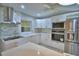 Modern kitchen featuring white cabinets, stone backsplash, and stainless steel appliances at 1919 19Th Nw St, Winter Haven, FL 33881