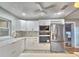 Modern kitchen with white cabinetry, stainless steel refrigerator, and marble backsplash at 1919 19Th Nw St, Winter Haven, FL 33881