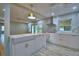 Bright open-concept kitchen with island, white cabinetry, and hardwood floors at 1919 19Th Nw St, Winter Haven, FL 33881