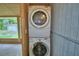 Convenient laundry area with stacked washer and dryer units for space-saving efficiency at 1919 19Th Nw St, Winter Haven, FL 33881