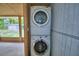 Laundry area featuring a stacked washer and dryer and access to the exterior at 1919 19Th Nw St, Winter Haven, FL 33881