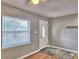 Living room featuring refinished hardwood floors, a window, and a light gray door at 1919 19Th Nw St, Winter Haven, FL 33881