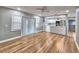 A spacious living room with beautiful hardwood floors and a clear view of the modern kitchen at 1919 19Th Nw St, Winter Haven, FL 33881