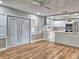 Spacious living area with hardwood floors, double doors, and view of the modern kitchen at 1919 19Th Nw St, Winter Haven, FL 33881