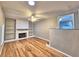 Bright living room featuring hardwood floors, a fireplace, and built-in shelving at 1919 19Th Nw St, Winter Haven, FL 33881