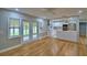 Living room view of bright kitchen, hardwood floors, and access to lanai at 1919 19Th Nw St, Winter Haven, FL 33881