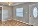Living room with refinished hardwood floors, a window, and a light gray door at 1919 19Th Nw St, Winter Haven, FL 33881