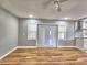 An airy living room features beautiful hardwood flooring, complemented by double doors and natural light at 1919 19Th Nw St, Winter Haven, FL 33881