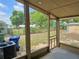 View from a screened porch, showcasing the outdoor space and surrounding greenery at 1919 19Th Nw St, Winter Haven, FL 33881