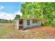 Exterior shot of the backyard shed featuring ample natural light and space for storage at 1919 19Th Nw St, Winter Haven, FL 33881