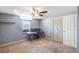 Bedroom provides a calm atmosphere with its soft gray walls, ceiling fan, and natural light from the window at 211 Pierce St, Lake Wales, FL 33859