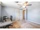 Bedroom features a ceiling fan, closet, neutral walls, and a computer setup, ideal for work or study at 211 Pierce St, Lake Wales, FL 33859