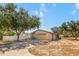 Inviting one-story home with an attached garage, well-maintained lawn, and flagpole displaying the American flag at 211 Pierce St, Lake Wales, FL 33859