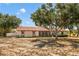 Charming one-story home featuring a spacious yard and beautiful mature trees providing ample shade at 211 Pierce St, Lake Wales, FL 33859